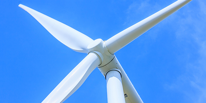 Picture of a wind turbine rotor and blades and a beautiful blue sky