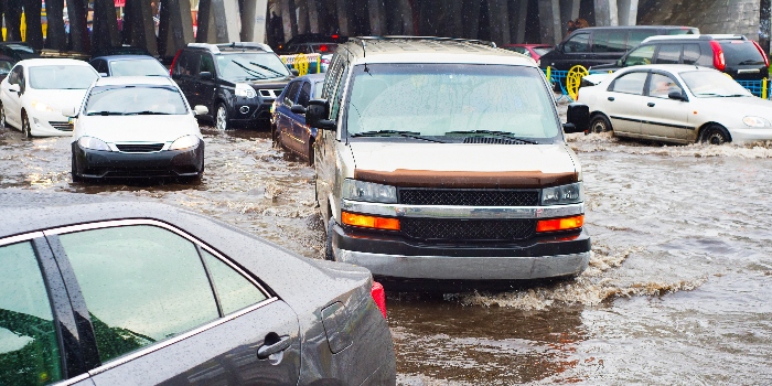 Heavy traffic on a flooded city road in the rain