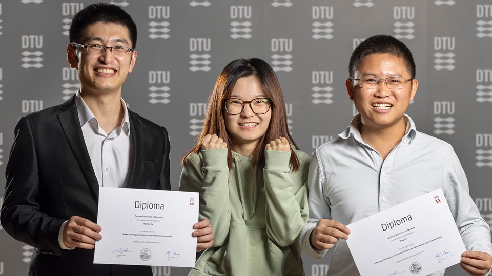 PhD candidates pose with their congratulatory diplomas. 