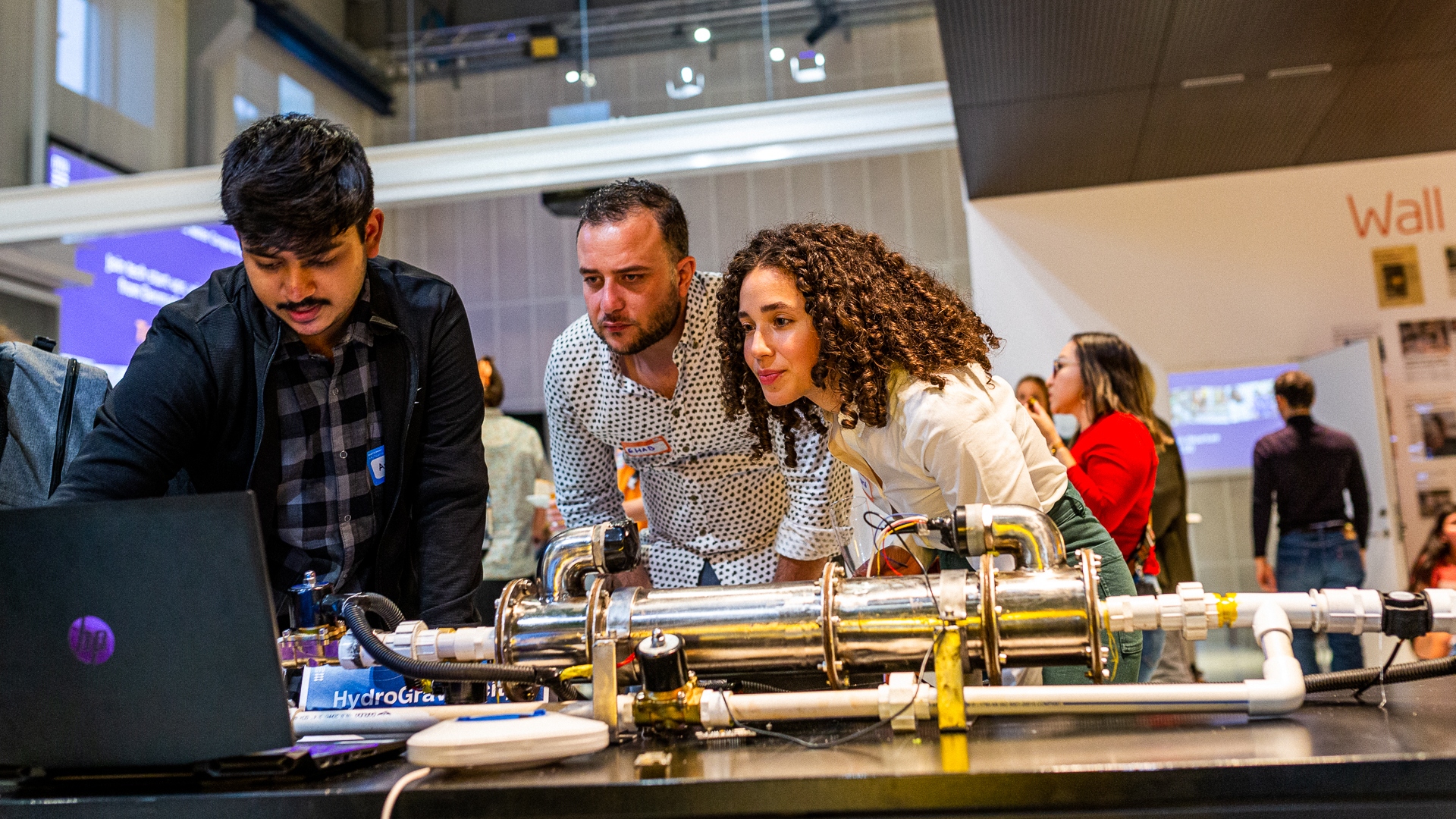 Three participants of Next Generation Water Action are looking at a computer screen