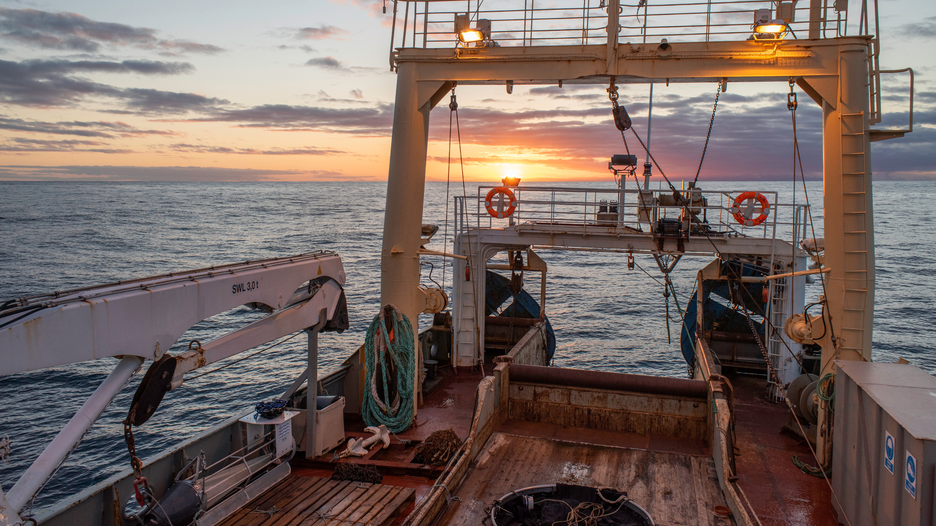 The sunset from a marine research ship during experimental fisheries in the Nordic region.