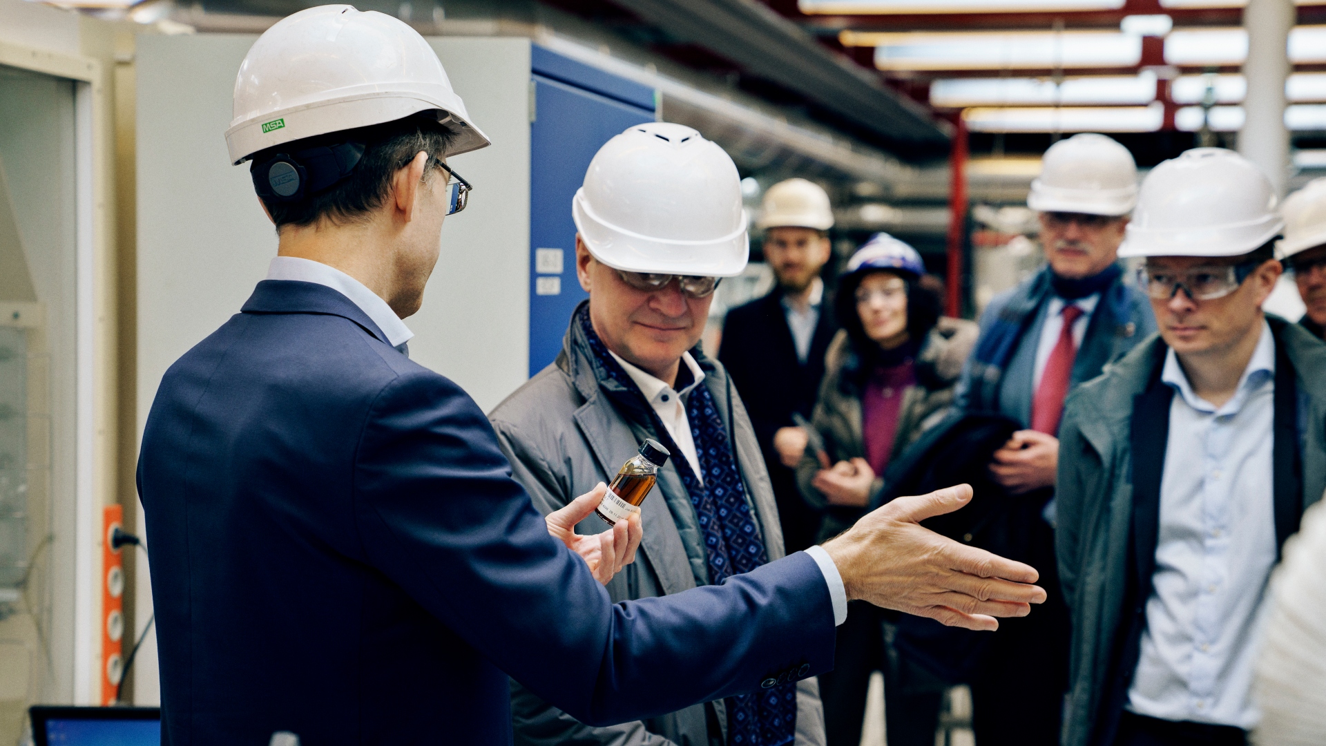 Professor Anker Degn Jensen, DTU (Left) shows green aircraft fuel to CEO Thomas Wolbye Copenhagen Airports.