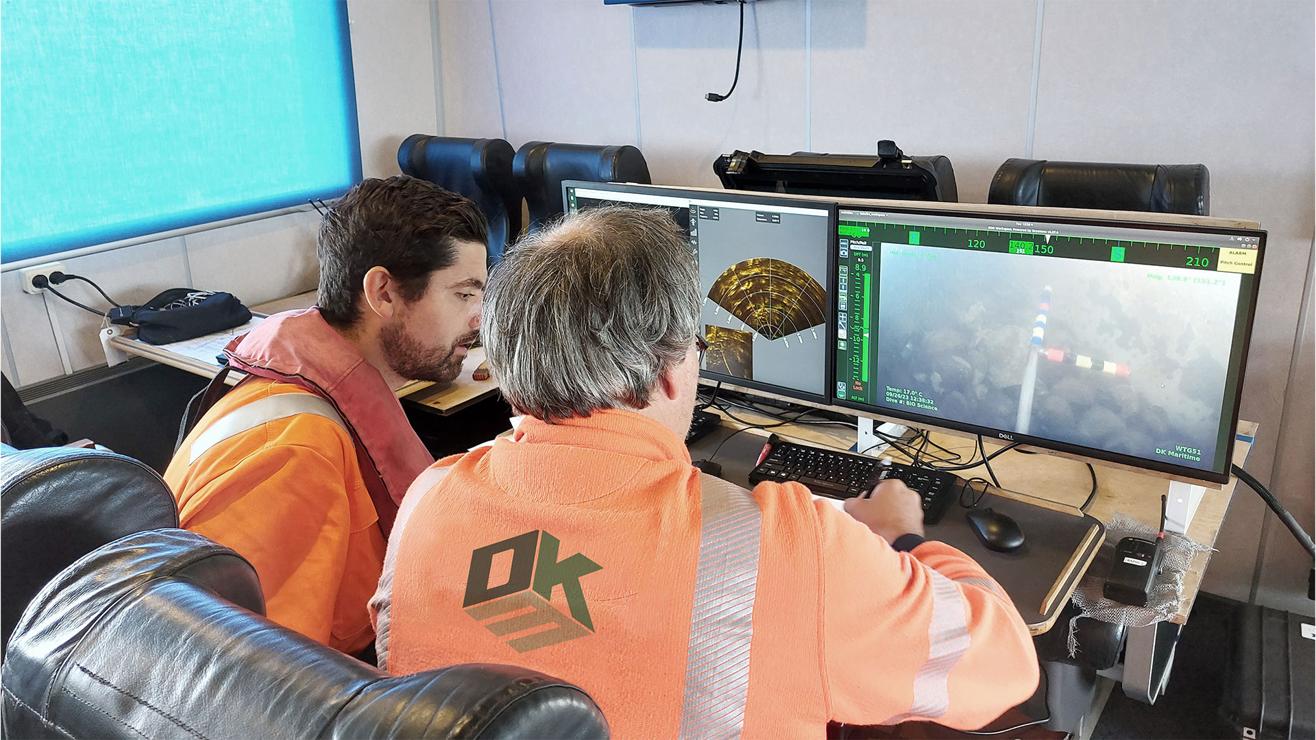 Two men sitting at a couple of computer screens. Liv Kristensen Stranddorf